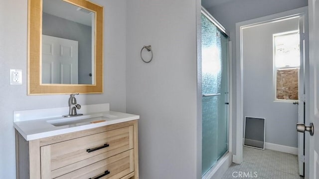 bathroom with tile patterned flooring, vanity, and a shower with door