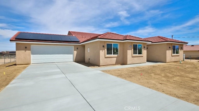 view of front of house with solar panels and a garage