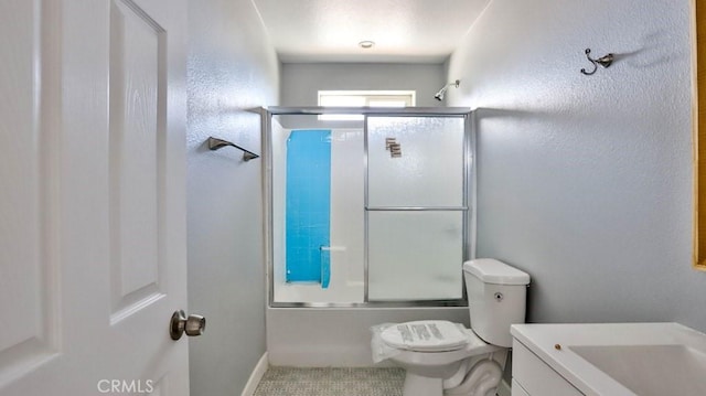 full bathroom featuring tile patterned floors, vanity, toilet, and bath / shower combo with glass door