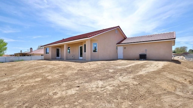 back of house with central AC