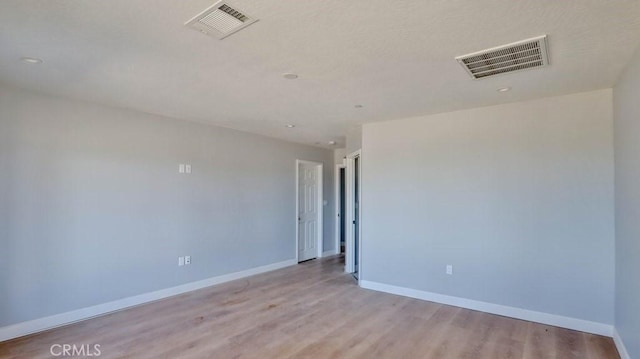 spare room with light hardwood / wood-style flooring