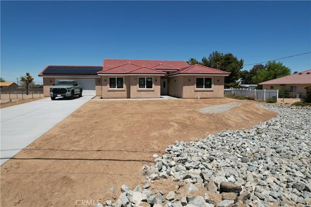 view of front of house with solar panels and a garage