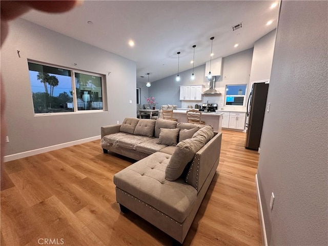 living room featuring light hardwood / wood-style floors and lofted ceiling