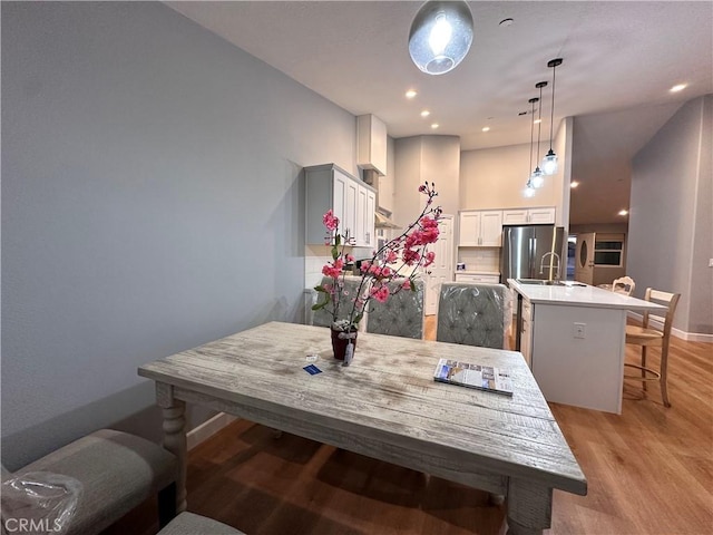 dining area featuring light hardwood / wood-style flooring and sink