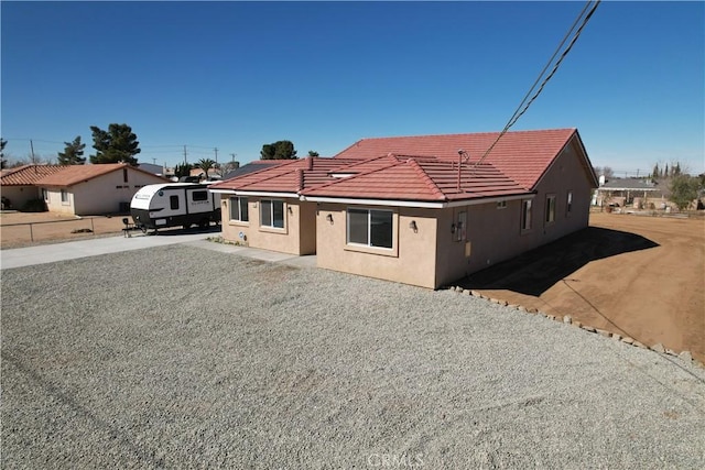 view of front of property featuring a tile roof and stucco siding