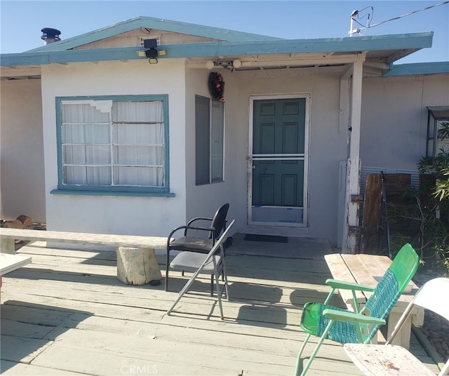 doorway to property featuring a wooden deck