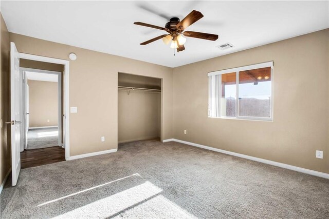 unfurnished bedroom featuring ceiling fan, a closet, and carpet floors