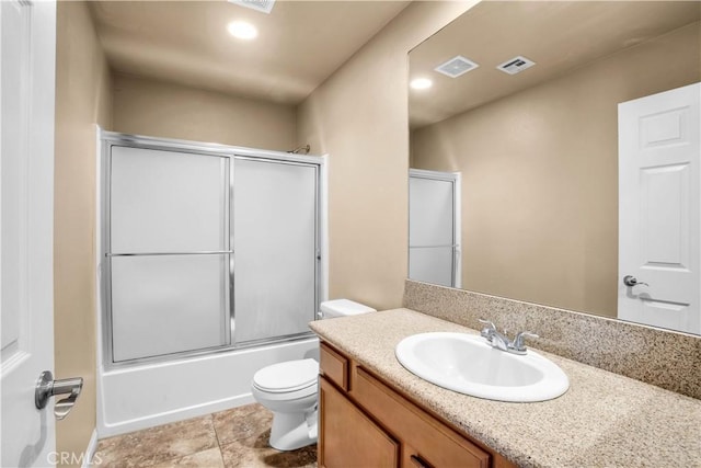 full bathroom with combined bath / shower with glass door, vanity, and toilet