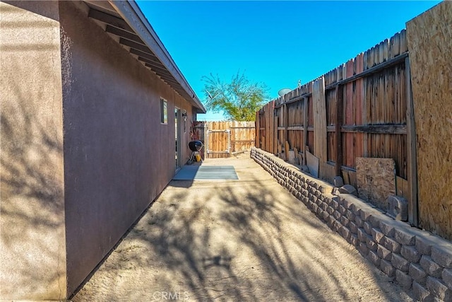 view of property exterior with a patio area