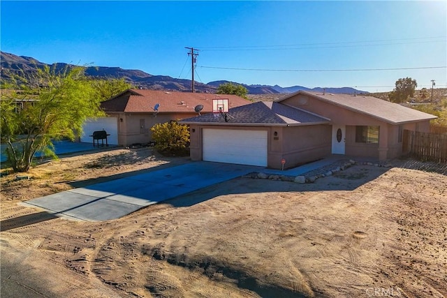 ranch-style home featuring a mountain view and a garage