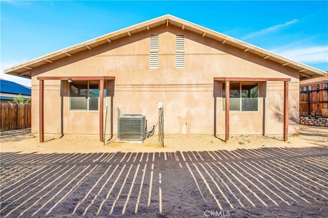 rear view of house with cooling unit