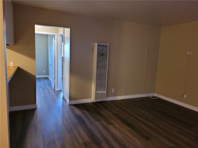 unfurnished room featuring dark wood-type flooring