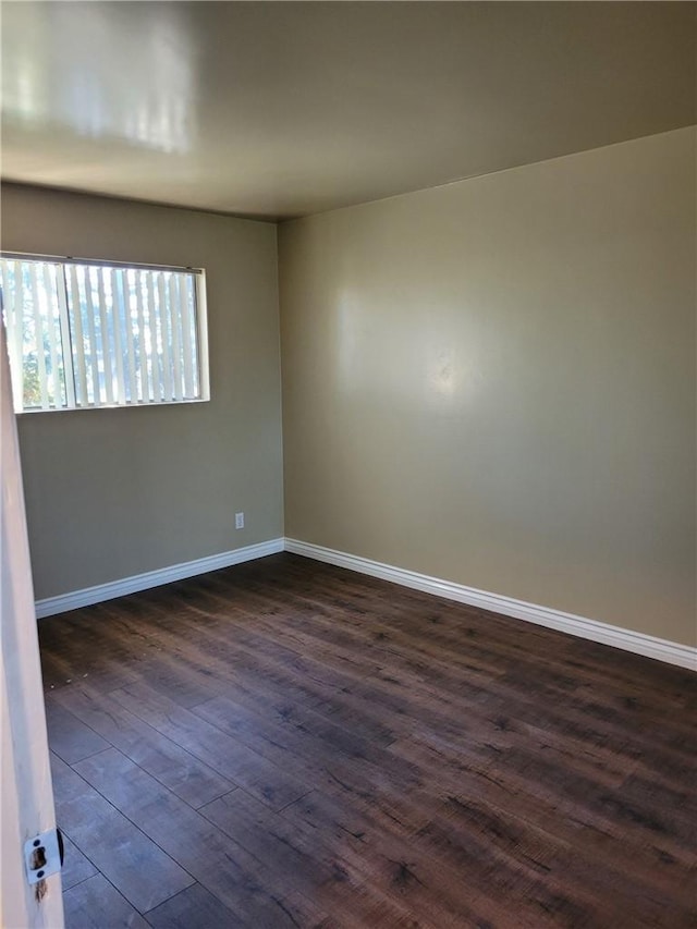 unfurnished room featuring dark hardwood / wood-style flooring