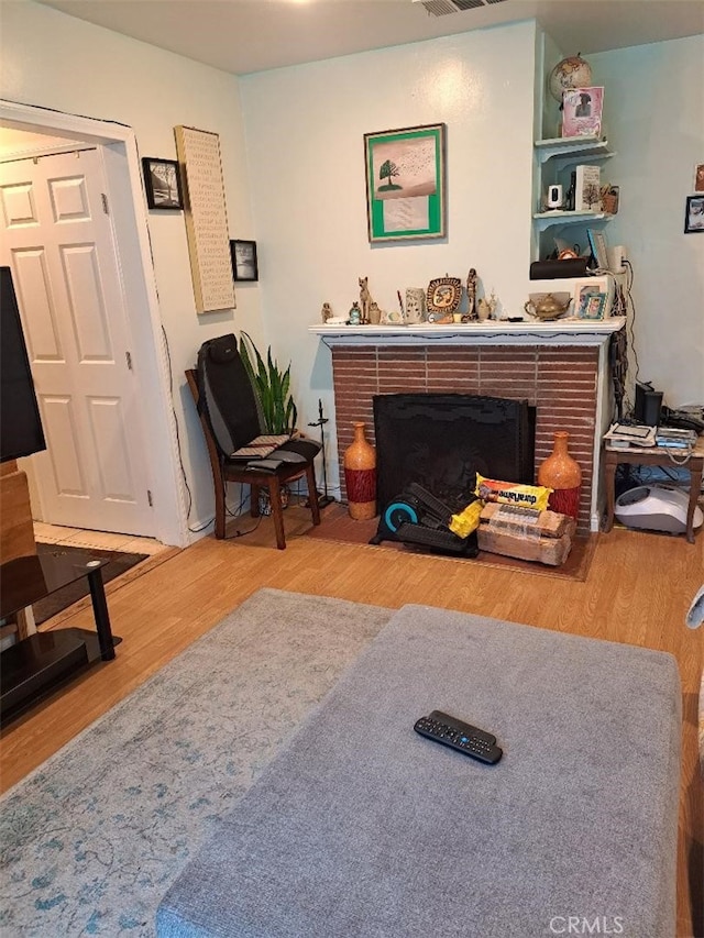 living room with hardwood / wood-style floors and a fireplace