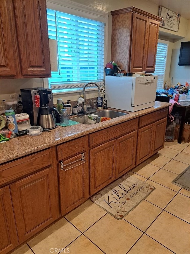 kitchen with light tile patterned flooring and sink