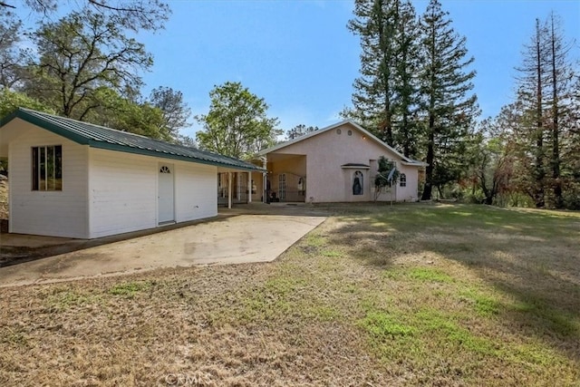 back of house with a patio and a yard