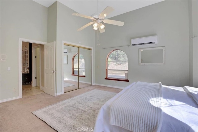 bedroom with high vaulted ceiling, an AC wall unit, a closet, ceiling fan, and light carpet