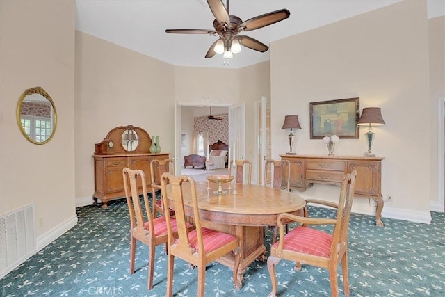 carpeted dining room featuring ceiling fan