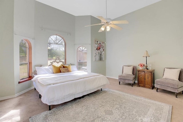 bedroom with high vaulted ceiling, ceiling fan, and carpet floors