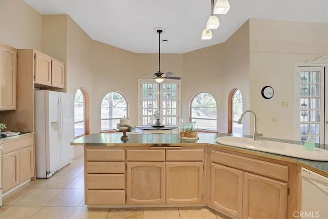 kitchen with light tile patterned floors, white appliances, ceiling fan, and a wealth of natural light