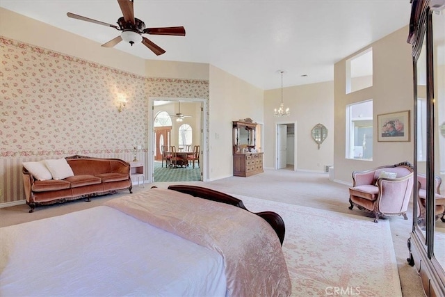 bedroom featuring light carpet and ceiling fan with notable chandelier