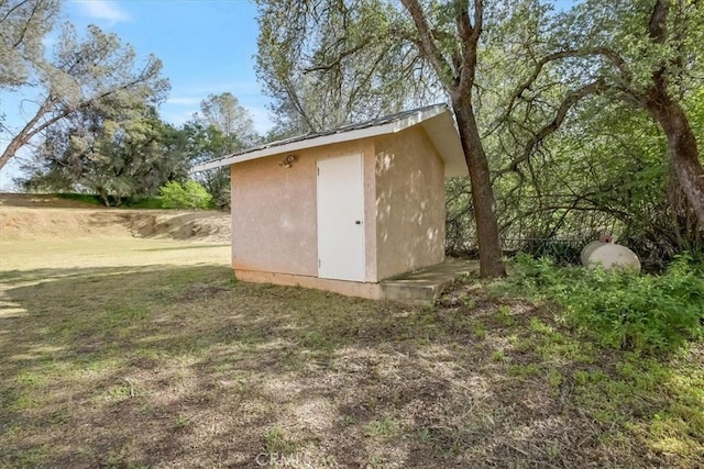 view of outbuilding with a lawn