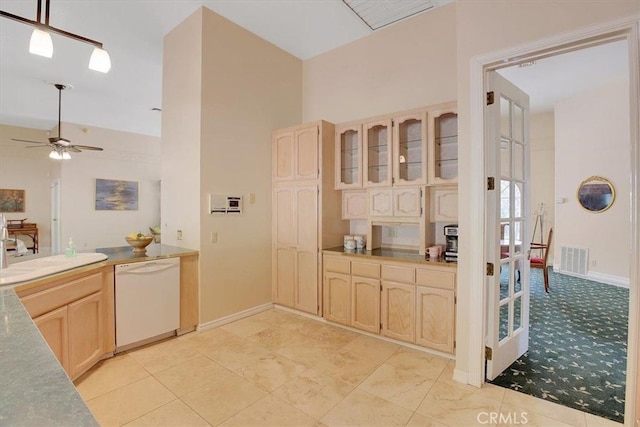 kitchen featuring a towering ceiling, light brown cabinets, dishwasher, ceiling fan, and sink