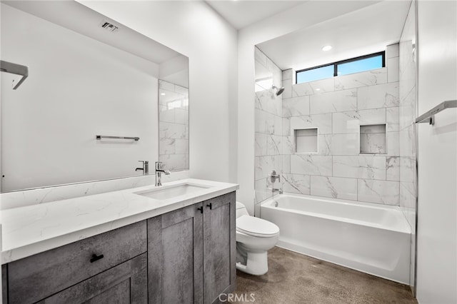 full bathroom featuring vanity, toilet, and tiled shower / bath