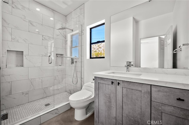 bathroom featuring vanity, toilet, and an enclosed shower