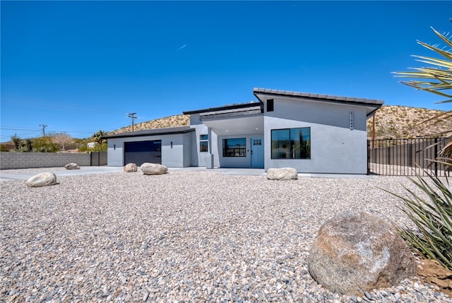 rear view of property with a garage