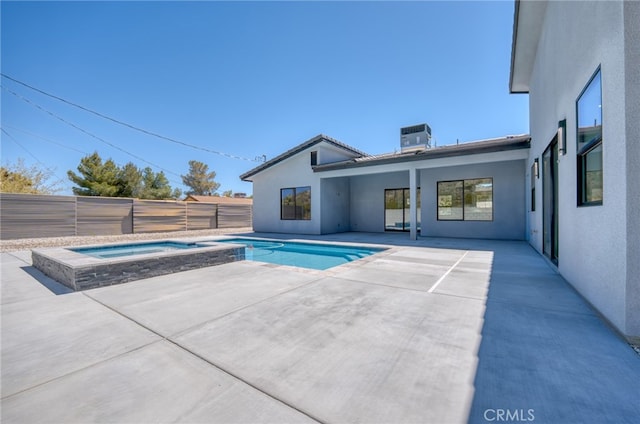 view of pool featuring an in ground hot tub, central air condition unit, and a patio area