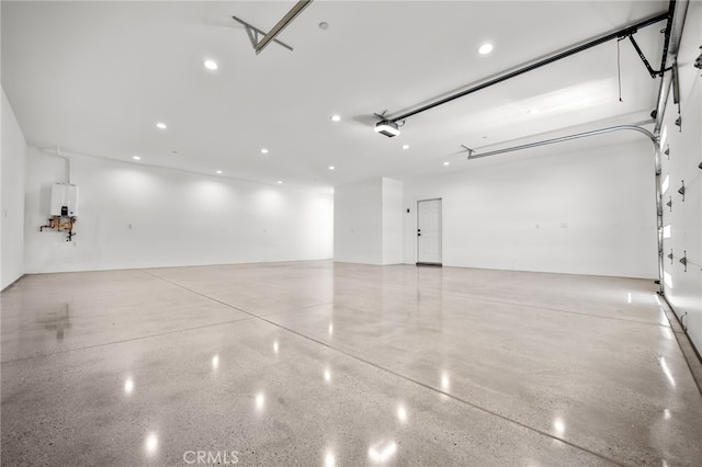 garage featuring a garage door opener and water heater