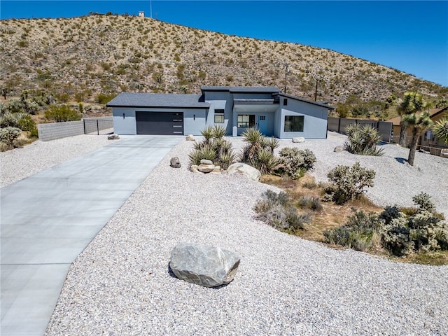 view of front of property featuring a garage and a mountain view