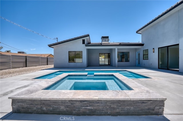 view of swimming pool with a patio and an in ground hot tub