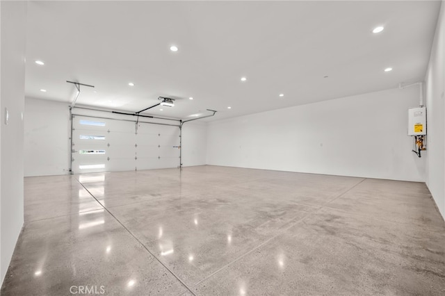 garage featuring a garage door opener and water heater