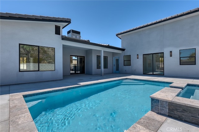 view of swimming pool featuring an in ground hot tub, central air condition unit, and a patio area