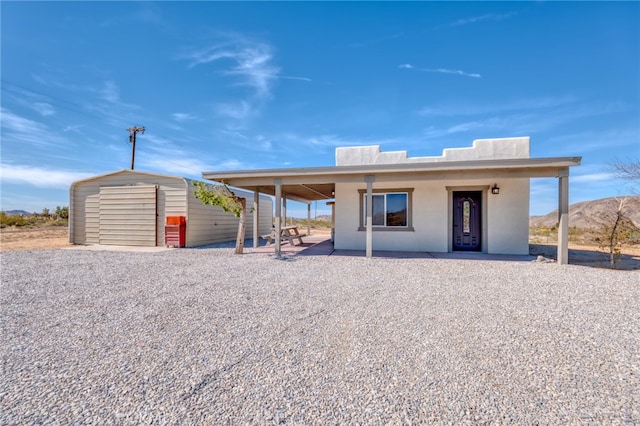 exterior space featuring a mountain view and a carport