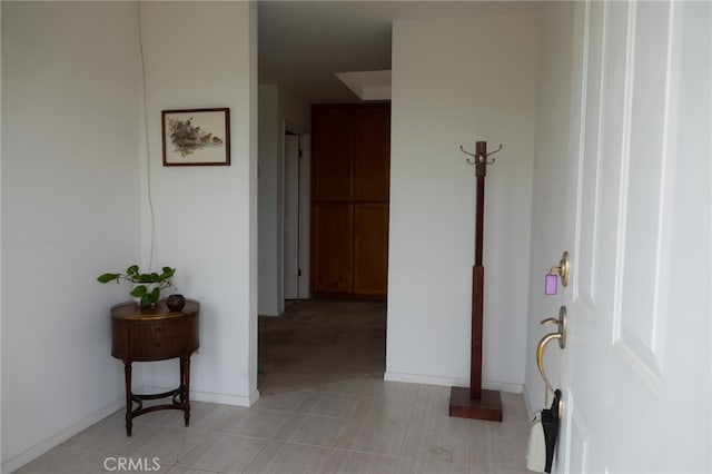 corridor featuring light tile patterned flooring