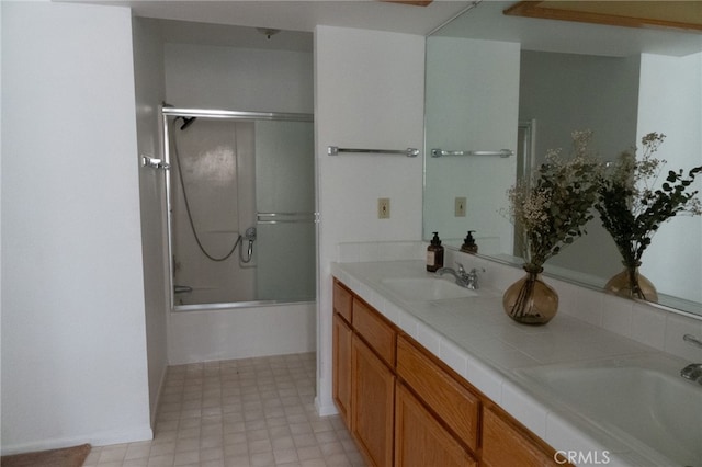 bathroom featuring vanity, enclosed tub / shower combo, and tile patterned floors