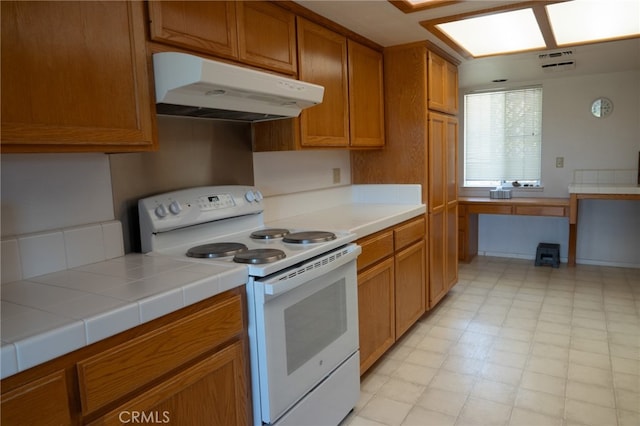 kitchen with tile counters and electric range