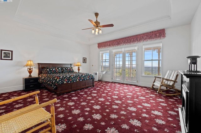 carpeted bedroom with a tray ceiling, ceiling fan, french doors, and crown molding