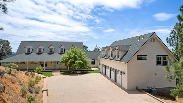 view of front of house featuring central AC and a garage