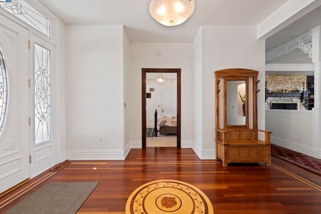 foyer with a healthy amount of sunlight and dark hardwood / wood-style floors