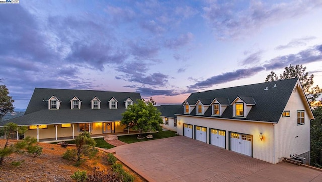 cape cod home with a garage