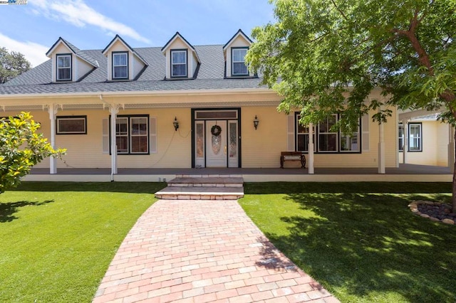 new england style home with covered porch and a front lawn