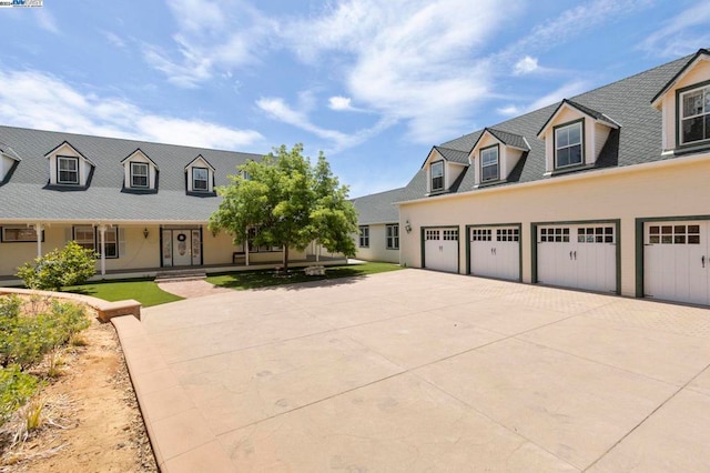 cape cod home with a garage