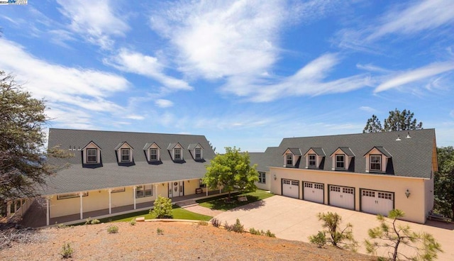 cape cod-style house featuring a garage