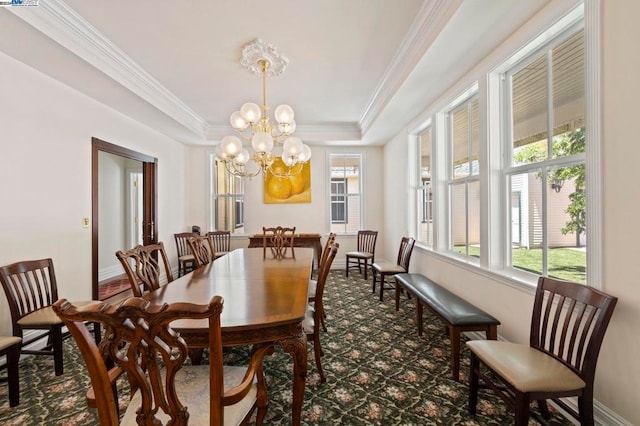 dining area with plenty of natural light, a chandelier, and ornamental molding