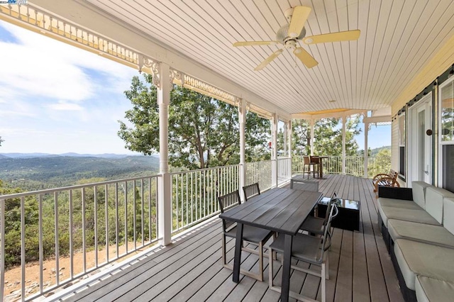 wooden deck featuring ceiling fan