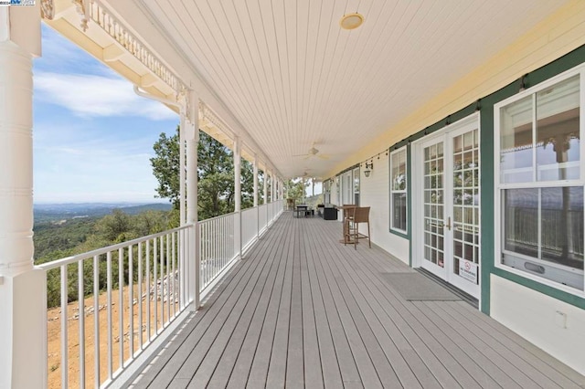 wooden deck featuring french doors and ceiling fan